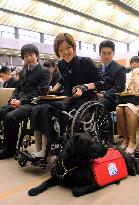 Wheelchair-bound woman 1st to attend university with dog